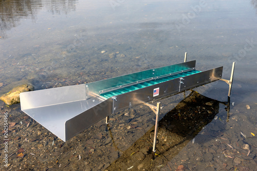 Sluice or washing ramp in situation in the water to search for gold in the river
