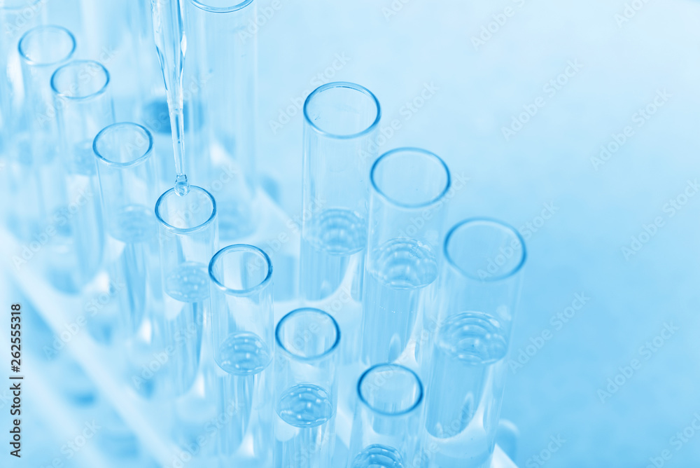 Laboratory beaker in analyst's hand in plastic glove Laboratory beaker in analyst's hand in plastic glove