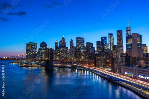 Brooklyn Bridge in Manhattan downtown with Cityscape at sunset New York USA © Worawat