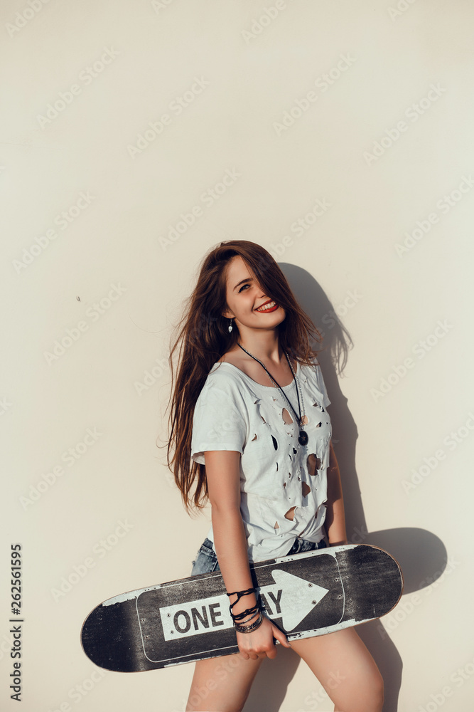 emotional portrait of Fashion stylish portrait of pretty young hipster blonde woman,going crazy,elegant black hat,soft colors,cool crazy  girl.Red urban wall background.surprised girl close up, sunset