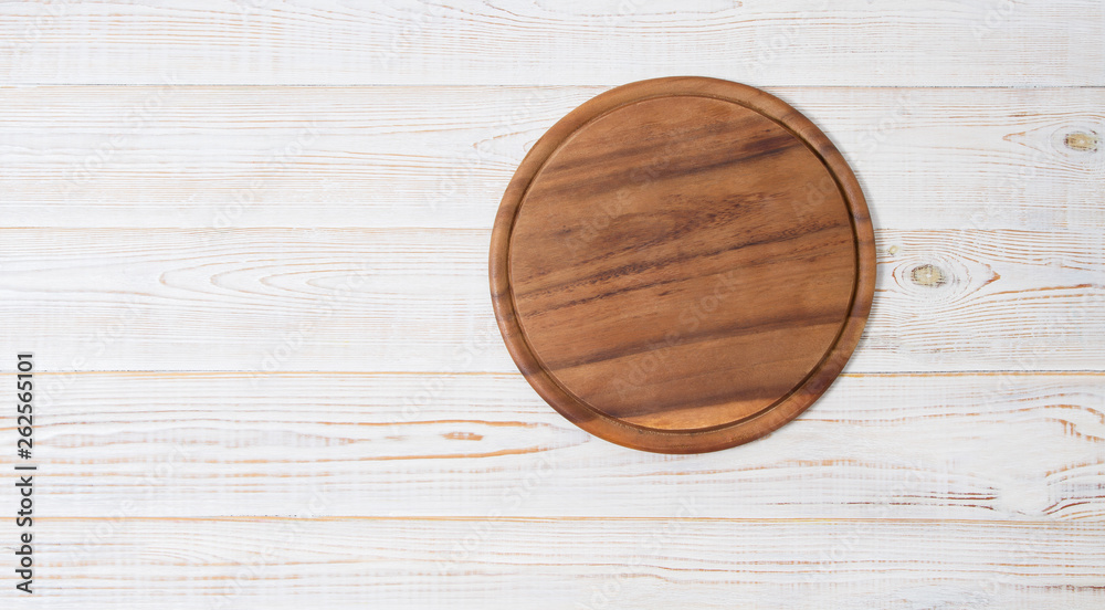 Round pizza cutting board on kitchen white wooden table background. Top view and copy space. Banner Round pizza cutting board on kitchen white wooden table background. Top view and copy space. Banner