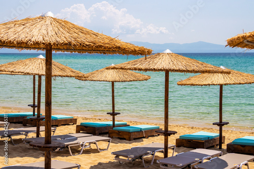 Empty sunbeds and sunshades at Ammolofoi Beach, Kavala Region, Northern Greece © Stanislava