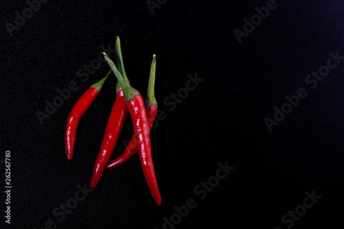 Pods of red hot pepper isolated on black color background.