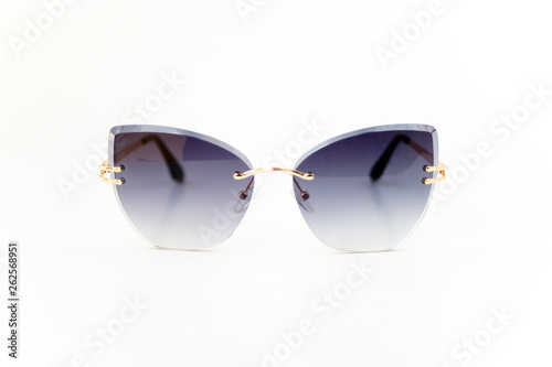 Isolated image of black gradient frame-less sunglasses with gold color earpiece. Front view.