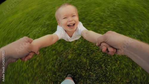 Dad hands holding spinning little happy smiling cute son playing together POV shot