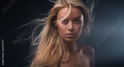 Portrait of a beautiful girl with flying blond hair