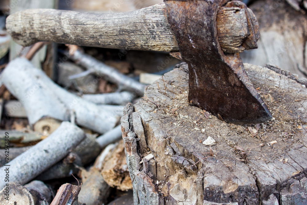 old metal rusty ax sticks out in wooden deck old metal rusty ax sticks out in wooden deck