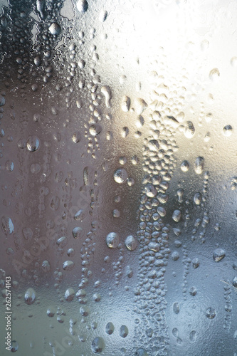 Rain drops on window glasses surface with cloudy background . Natural Pattern of raindrops cloudy background.