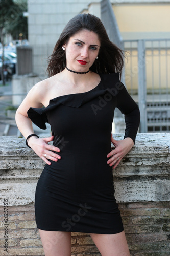 Young woman in tight black dress