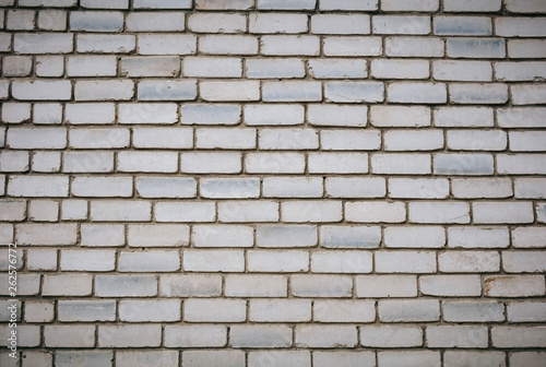 Wall is made from bricks and painted with white color.