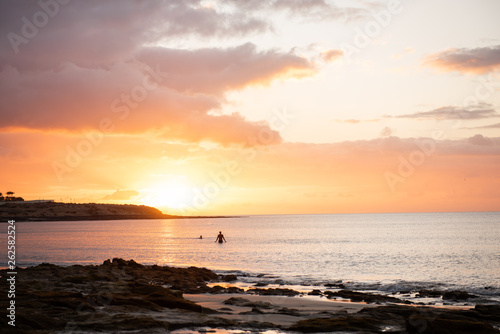 siluet  in a ocean sea against sun set 