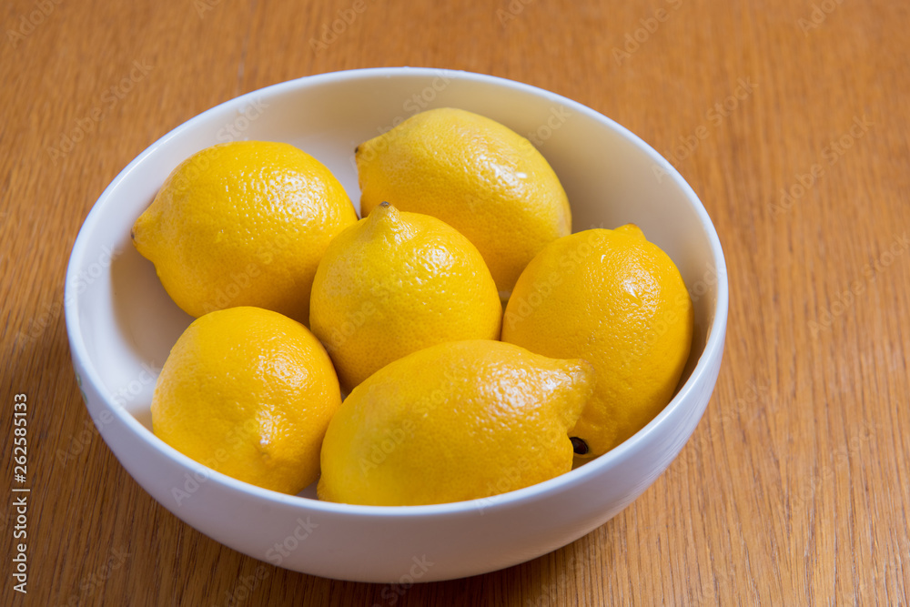 Fresh yellow lemons on a wooden background.. sweet lime, vitamin c.