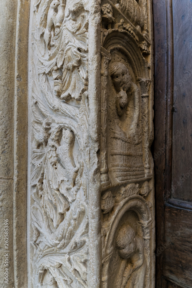 Detail of a medieval door carvings outside an italian cathedral