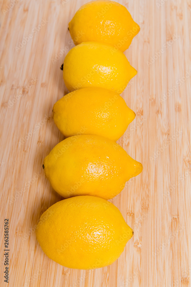 Fresh yellow lemons on a wooden background.. sweet lime, vitamin c.