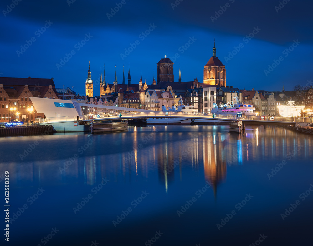 Night view at the old town of Gdansk. City lights reflection in Motlawa river.