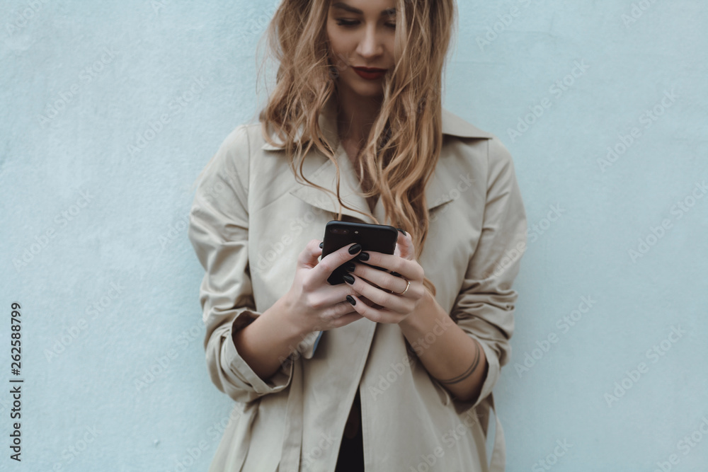 Fototapeta premium young pretty woman posing in the street with phone, outdoor portrait, hipster girls, sisters, chic, tablet, internet, using smartphone, close-up fashion model, post in instagram, facebook
