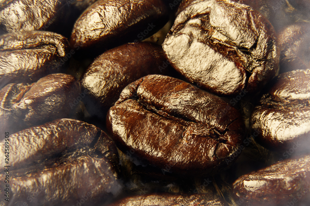 Fragrant fried coffee beans closeup, brown color.