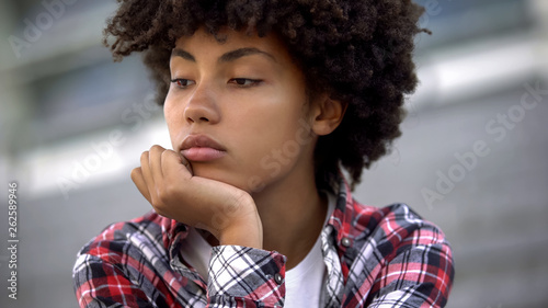 Tableau sur toile Upset afro-american woman portrait, racial discrimination problem, bullying