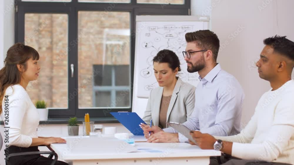 job, hiring and employment concept - international team of recruiters having interview with asian female employee at office job, hiring and employment concept - international team of recruiters having interview with asian female employee at office