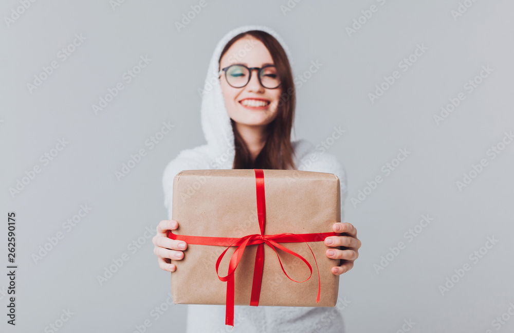 Beautiful girl in white rabbit costume hare posing in studio,and holding a beautiful gift box, laughing and smiling cheerfully, holiday atmosphere,new year and Christmas,outdoor portrait,glasses 2021 Beautiful girl in white rabbit costume hare posing in studio,and holding a beautiful gift box, laughing and smiling cheerfully, holiday atmosphere,new year and Christmas,outdoor portrait,glasses 2021