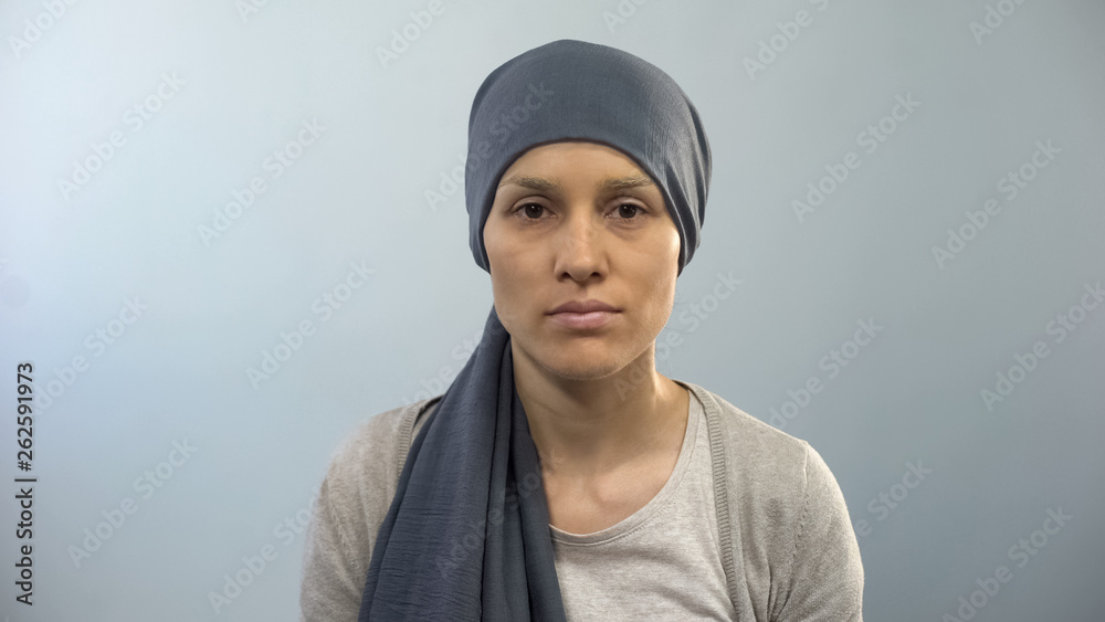 Hopeless woman with cancer sadly looking into camera hoping for social treatment Hopeless woman with cancer sadly looking into camera hoping for social treatment