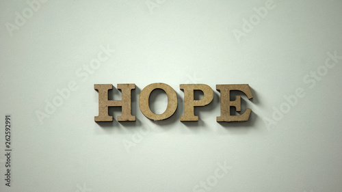 Hope word made of wooden letters lying on table, expectance of recovery, healing