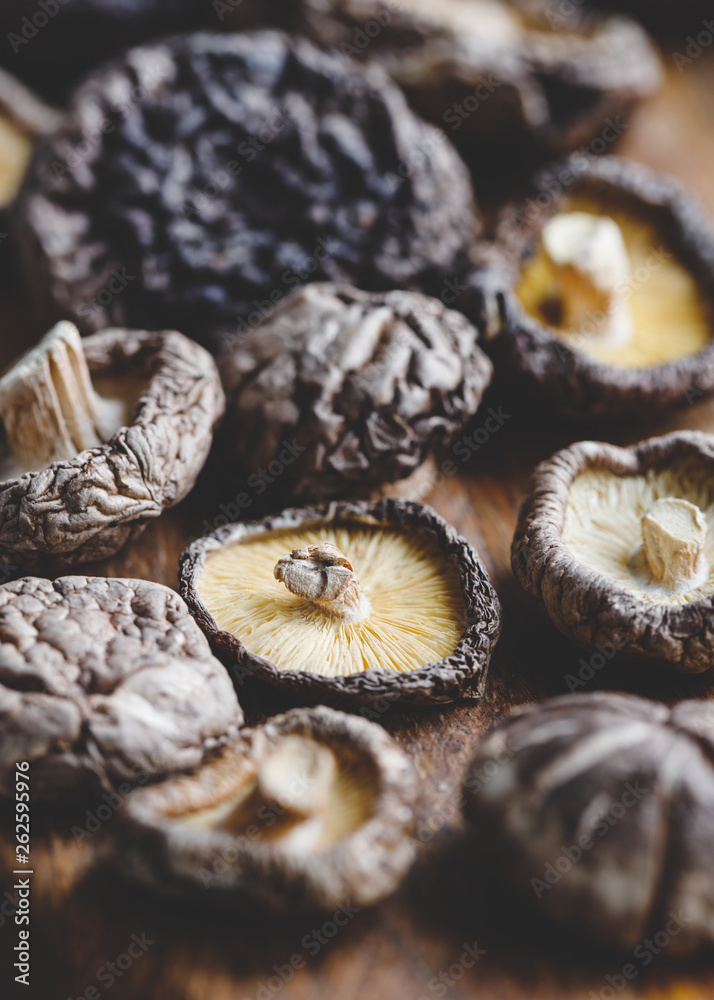 Macro photography of Chinese dried mushrooms Shiitake on a wooden kitchen board. Macro photography of Chinese dried mushrooms Shiitake on a wooden kitchen board.