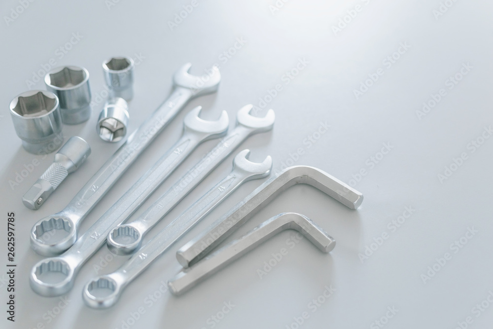 The wrench steel tools for repair and hexagon tool or allen wrench set on light gray background. The wrench steel tools for repair and hexagon tool or allen wrench set on light gray background.