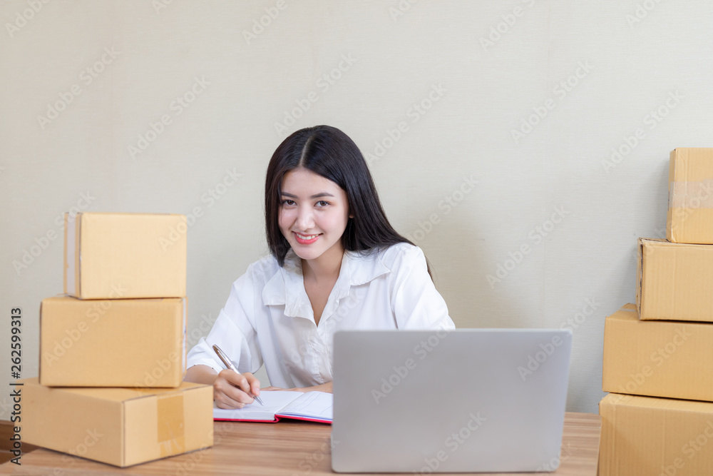 Beautiful Asian business young woman fell happy after receiving the email ordering product,startup small business owner working with computer at home office ,online market packaging box for delivery Beautiful Asian business young woman fell happy after receiving the email ordering product,startup small business owner working with computer at home office ,online market packaging box for delivery