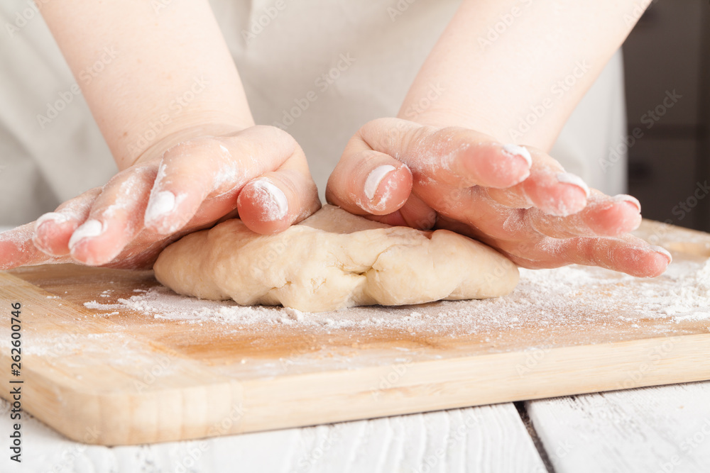 hands making dough on kitchen, close up view