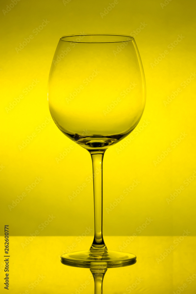 Empty wine glass on yellow background, empty wineglass Empty wine glass on yellow background, empty wineglass