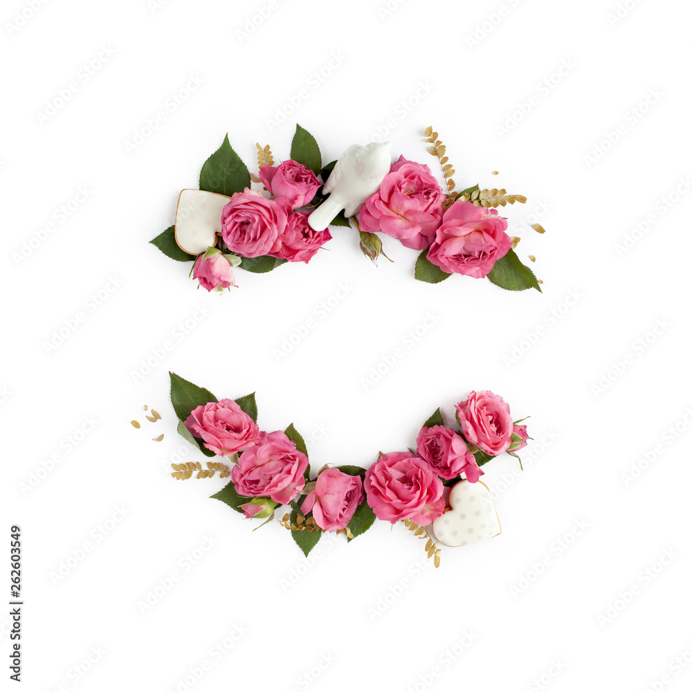 Floral frame wreath of rose flower buds, leaves and romantic decorations on white background mockup. Flat lay, top view.