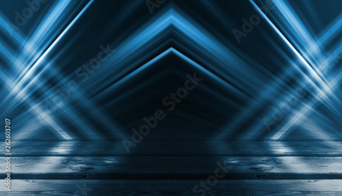 Background of empty street, room. Background of empty scene at night. Concrete coating. Reflection on wet pavement of neon lights. Neon blue lines. Dark abstract background.