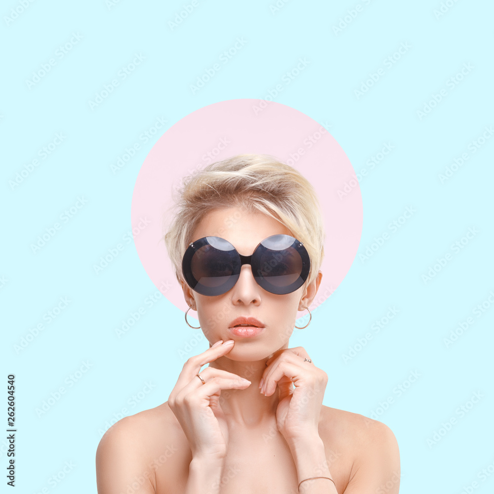 Conceptual stylish portrait of a young attractive blonde girl in round sunglasses. Conceptual stylish portrait of a young attractive blonde girl in round sunglasses.