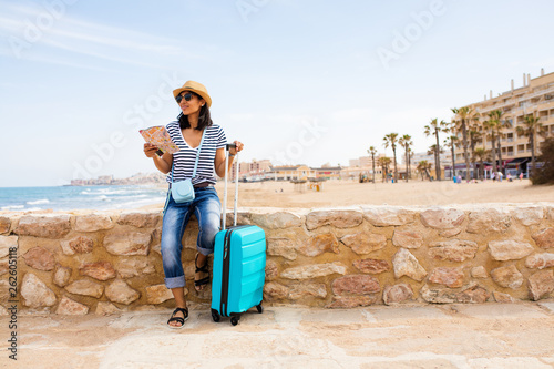 Young indian woman sitting in front of the sea