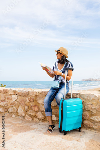 young Indian woman sitting in front of the sea