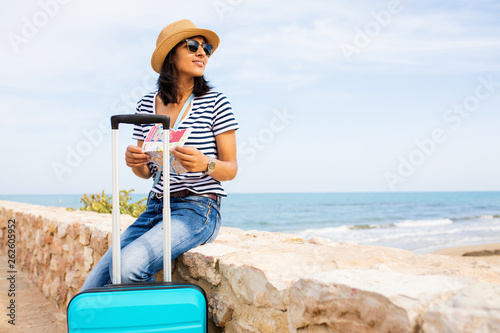 Young indian woman sitting in front of the sea