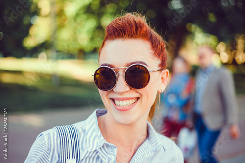 Young brunette girl in ,backpak, hair, smile,and watching the sunset in the city, the sun shines brightly, fashionable clothes on a girl, hipster style,bag, sun,street photo, mood, freedom, New York