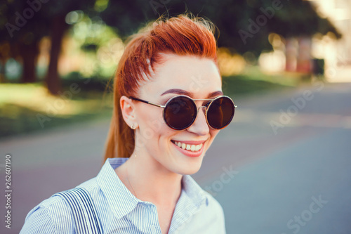 Young brunette girl in ,backpak, hair, smile,and watching the sunset in the city, the sun shines brightly, fashionable clothes on a girl, hipster style,bag, sun,street photo, mood, freedom, New York