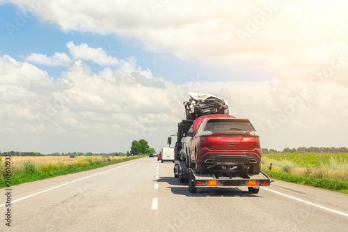 Wallpaper Mural Tow truck trailer on highway carrying three damaged cars sold on insurance car auctions for repair and recovery.  Vehicles shipment and rescue service Torontodigital.ca