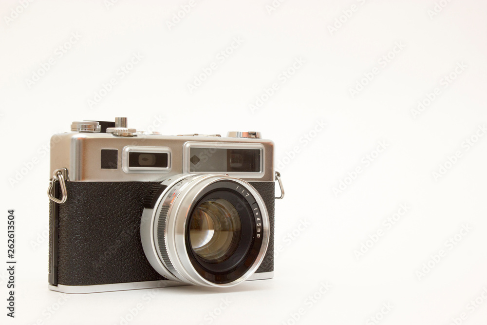 Old classic film photo camera on white background isolated with free space