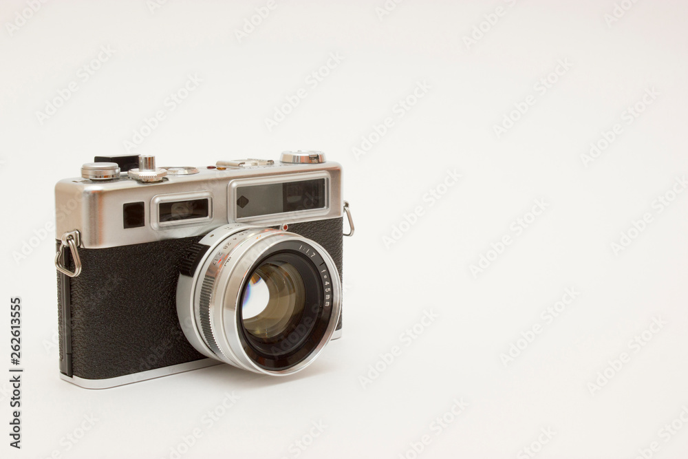 Old classic film photo camera on white background isolated with free space