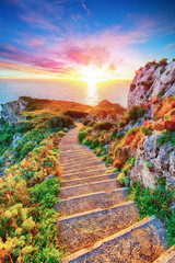 Dramatic spring sunset on the the cape Milazzo panorama of nature reserve Piscina di Venere.