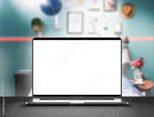 Laptop with blank screen  dark aluminium body. Laptop in focus.