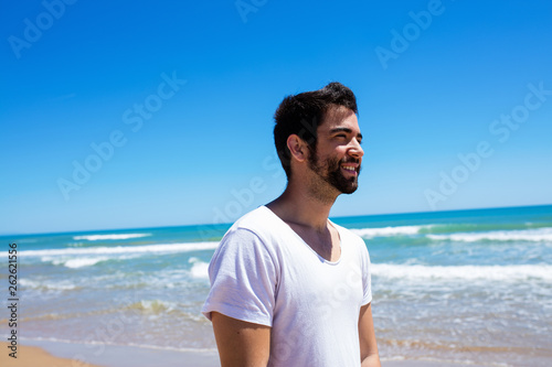 young man doing ok gesture on the beach