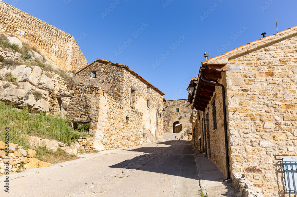 street with typical houses in Puertomingalvo village, province of Teruel, Aragon, Spain