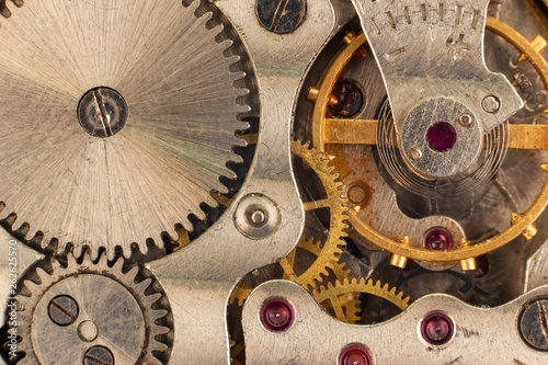 Rear view of on clockwork. Mechanical watch closeup