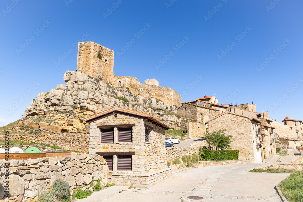 typical houses and the castle in Puertomingalvo village, province of Teruel, Aragon, Spain