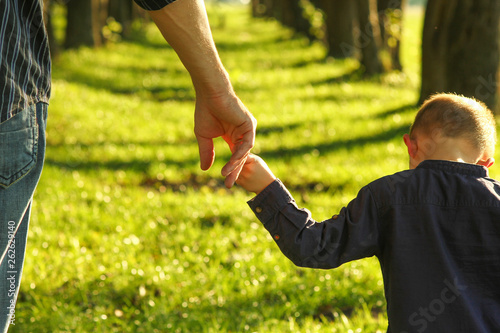  parent holds the hand of a small child