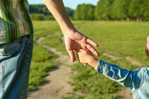  parent holds the hand of a small child